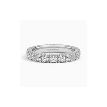 14K gold eternity band with lab-grown diamonds in a prong setting. A luxurious and timeless wedding or anniversary ring for women.
