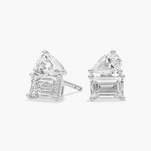14K white gold emerald and pear cut diamond stud earrings with secure push-back closures on a white background.


