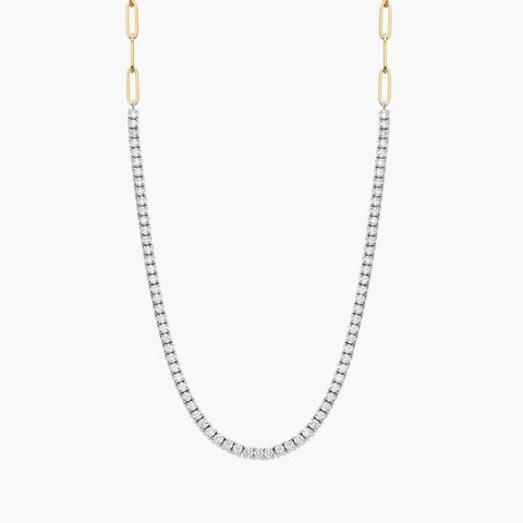 Two-toned 14K yellow gold paperclip and diamond tennis necklace worn by a woman.