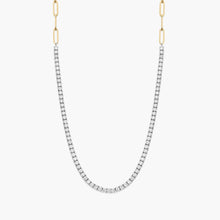 Two-toned 14K yellow gold paperclip and diamond tennis necklace worn by a woman.