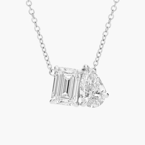 14K gold pendant necklace featuring emerald-cut and pear-shaped lab-grown diamonds on a delicate chain


