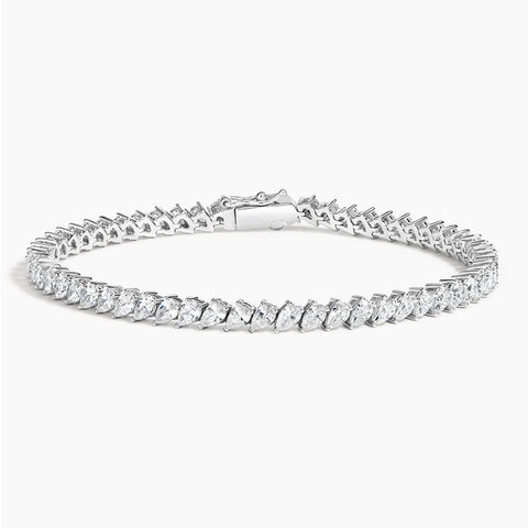 A stunning 14K gold diamond tennis bracelet featuring pavé-set teardrop diamonds, available in white, yellow, or rose gold. Luxury fine jewelry for women.

