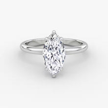 Elegant marquise diamond ring in 14K gold with pavé-set halo and cluster side accents, available in yellow, white, rose gold, or platinum.

