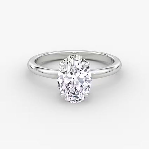 Side and front views of an oval-cut solitaire diamond engagement ring set in polished 14K white gold.