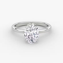 Side and front views of an oval-cut solitaire diamond engagement ring set in polished 14K white gold.