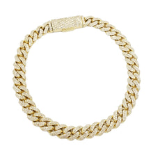 Close-up of 14K gold diamond Cuban link bracelet with pavé-set stones and secure box clasp, showcasing luxury and craftsmanship.

